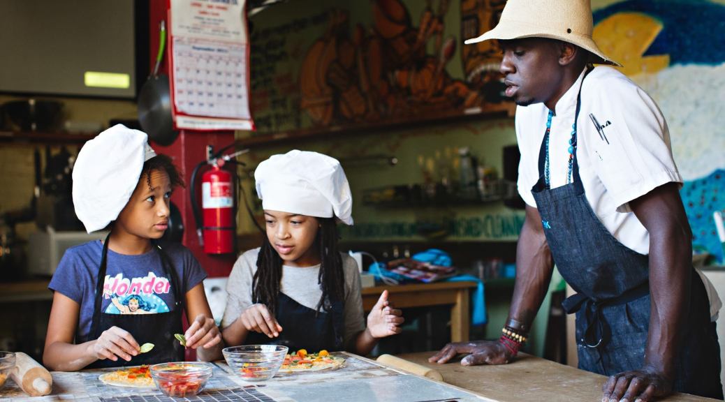Tarik Abdullah teaches two kids as part of his In The Kitchen culinary program